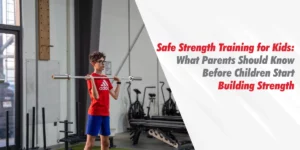A young boy in a red shirt practicing proper form with a barbell in a gym setting, illustrating the principles of safe strength training for kids.