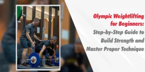 A professional fitness coach guiding a man through the starting position of a barbell lift, illustrating a guide to Olympic Weightlifting for Beginners in a modern gym setting.